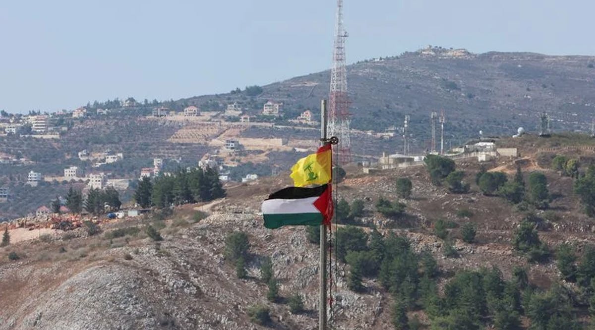 Palestinian and Hezbollah flags flutter in Khiam, near Lebanon's border with Israel