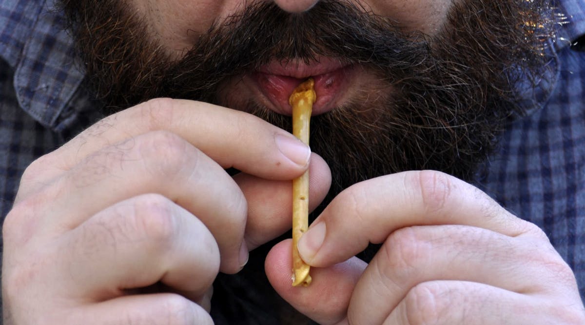 Hebrew University post-doctoral fellow Dr. Laurent Davin plays a recreated 12,000-year-old flute discovered in northern Israel