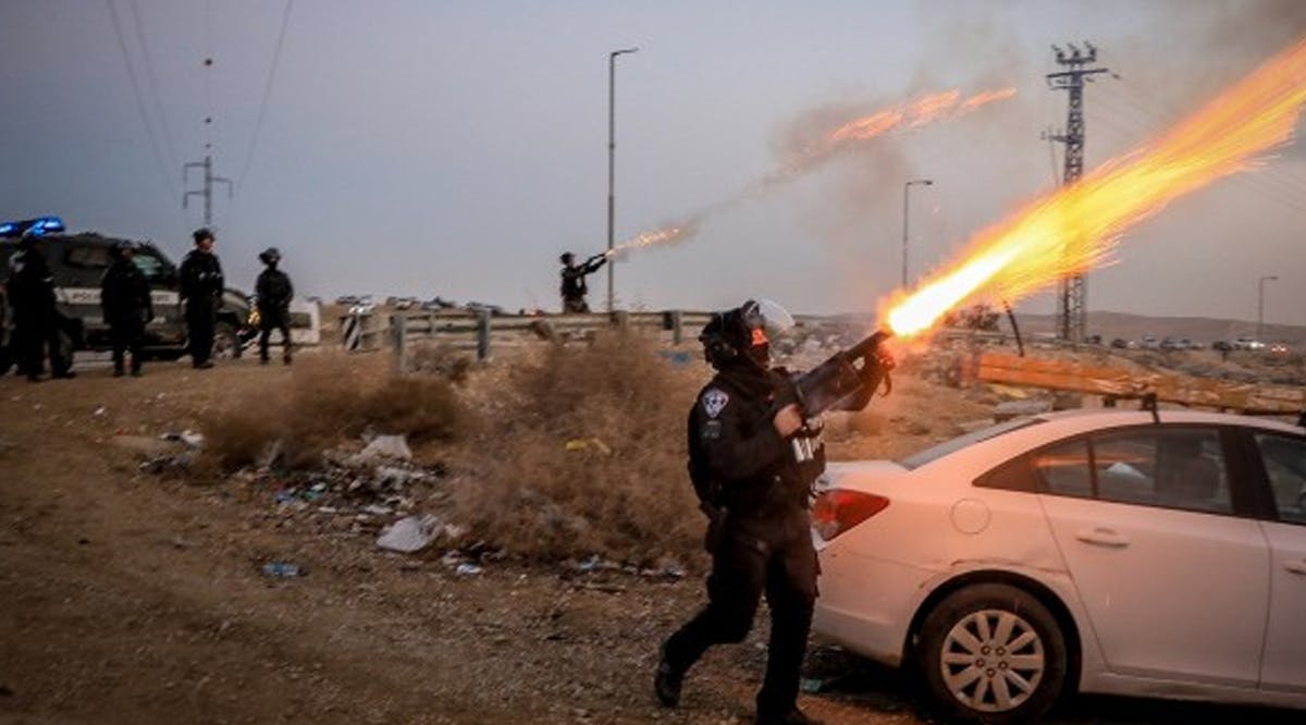 Israeli police officers clash with Bedouins during a protest against tree planting