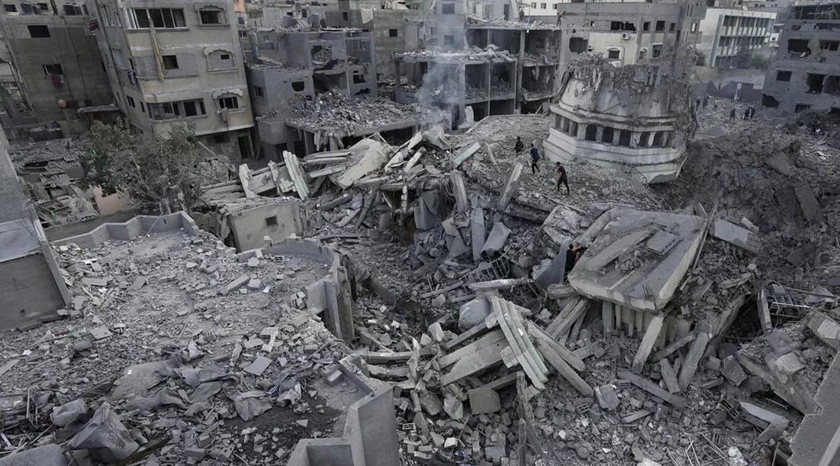 Palestinians inspect the rubble