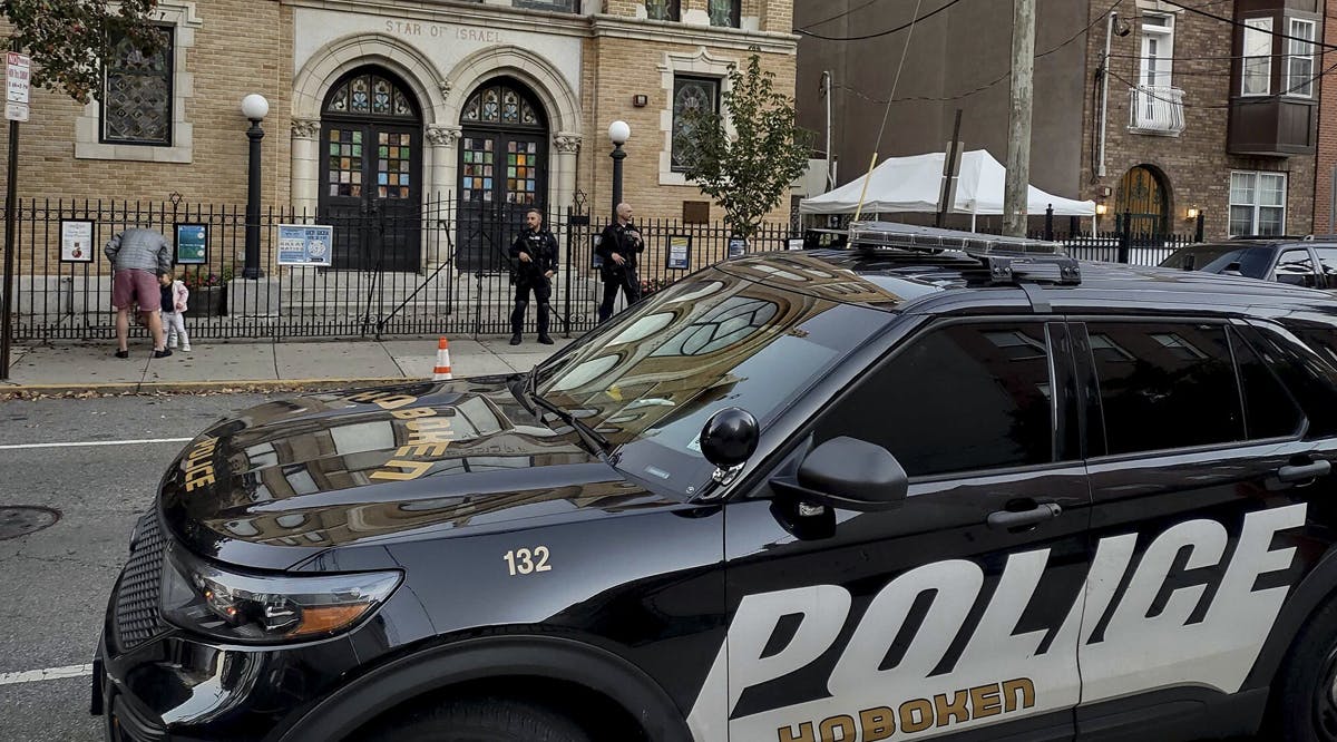 Police officers stand watch outside the United Synagogue of Hoboken, New Jersey