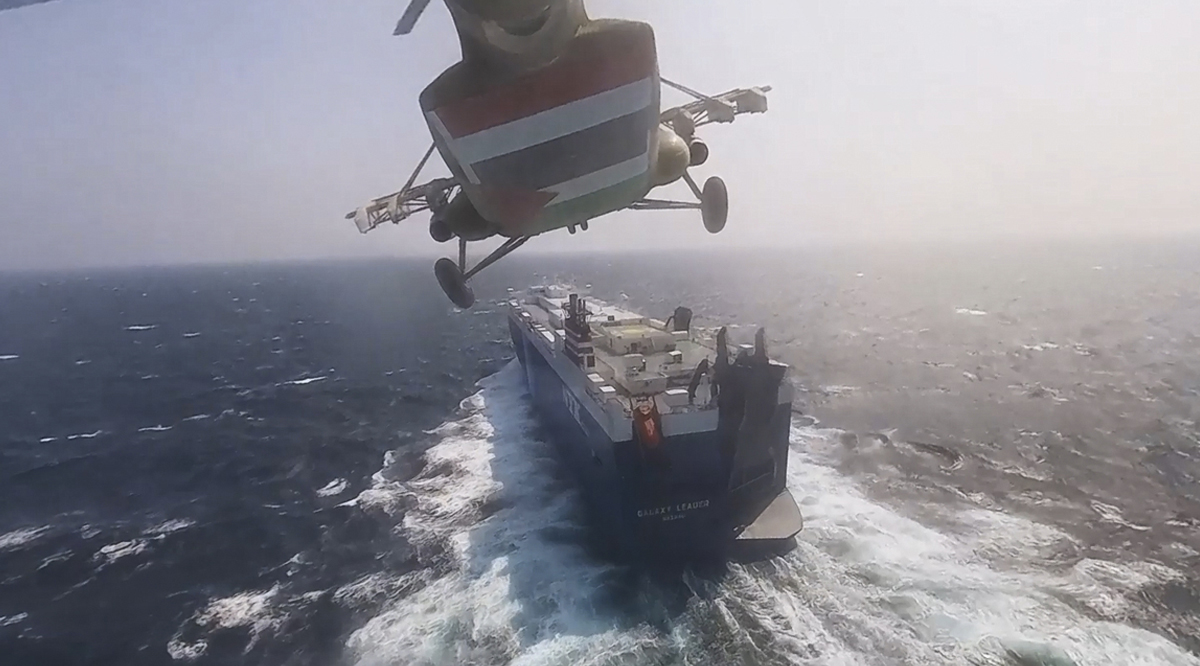Houthi forces helicopter approaching the cargo ship Galaxy Leader