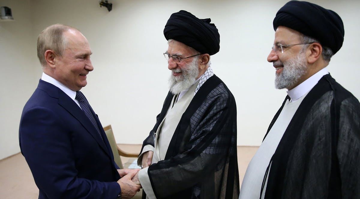 Supreme Leader Ayatollah Ali Khamenei, center, and Russian President Vladimir Putin, left, greet each other as Iranian President Ebrahim Raisi stands at right, during their meeting in Tehran, Iran
