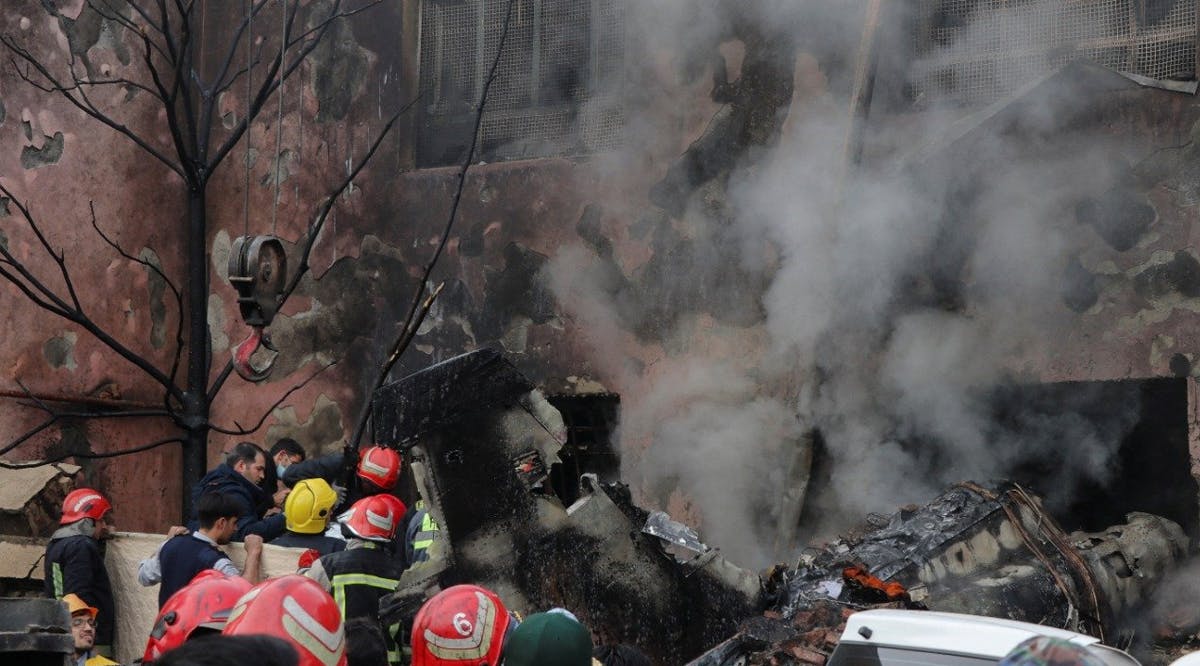 First responders work amid debris from the crashed fighter jet, in Tabriz, Iran
