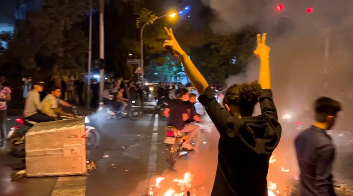 A man gestures during a protest over the death of Mahsa Amini, a woman who died after being arrested by the Islamic republic's "morality police", in Tehran, Iran