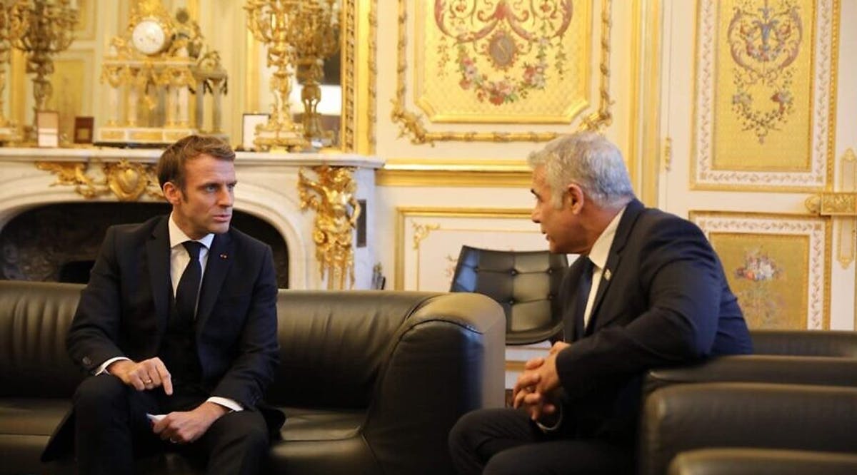 Then-Israeli Foreign Minister Yair Lapid meets with French President Emmanuel Macron in Paris