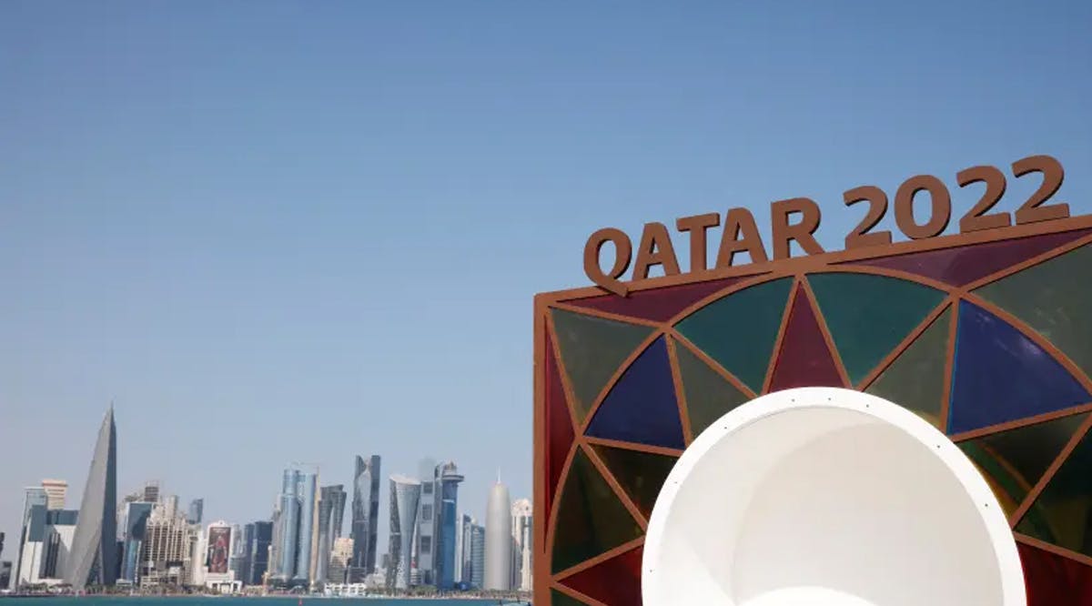 Qatar 2022 logo is seen in front of the skyline of the West Bay in Doha