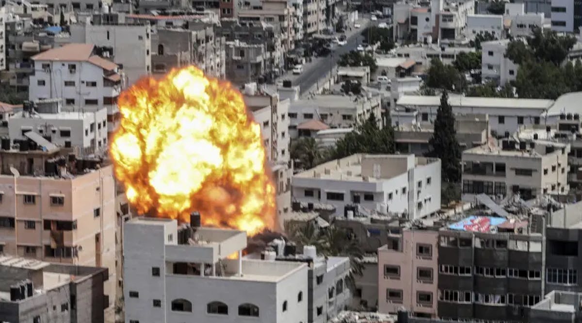 A fireball and smoke erupt following an Israeli air strike on a building in Gaza City