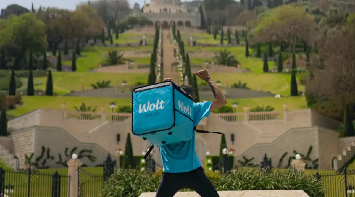 A Wolt courier takes flight before the fabled Baha'i Gardens