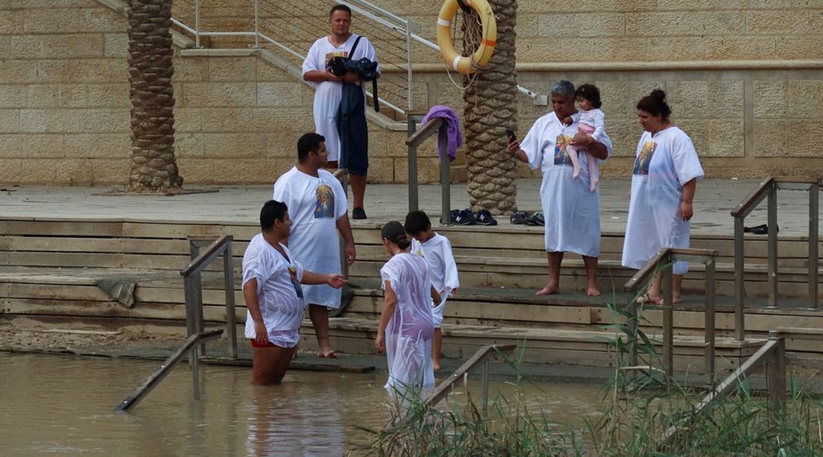 People dip themselves in Jordan River at the Qasr el-Yahud site, near Jericho