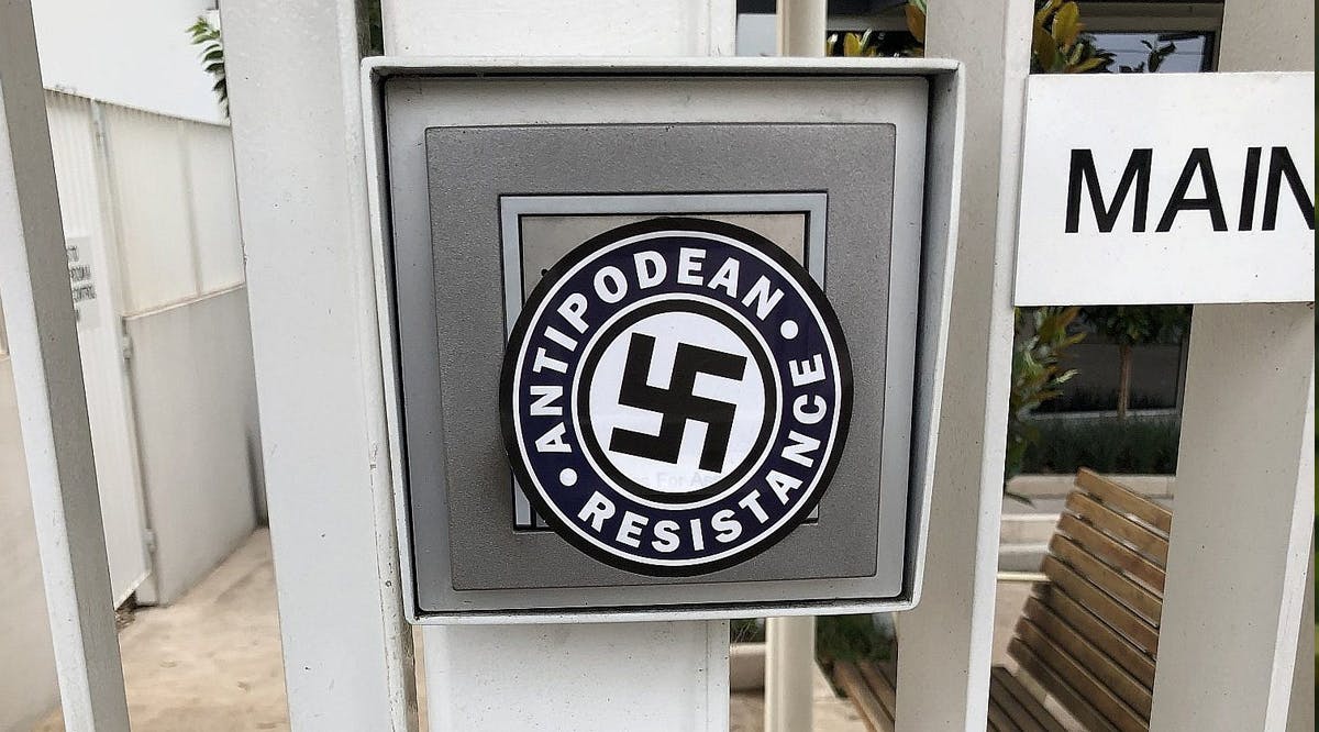 The swastika logo of Antipodean Resistance found on the front gates of Emmy Monash Aged Care in south-east Melbourne, Australia