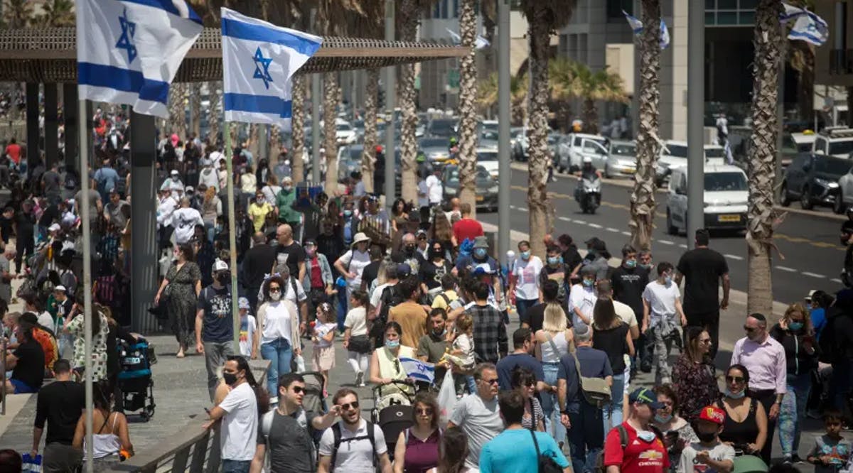 Thousands of Israelis walk on the beach boardwalk in Tel Aviv