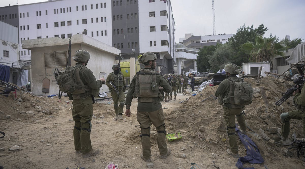 Israeli soldiers stand outside Shifa Hospital in Gaza City