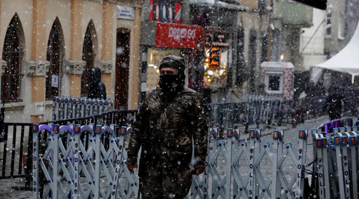 A member of Turkish Police Special Forces stands guard at the entrance of a street leading the Neve Shalom Synagogue