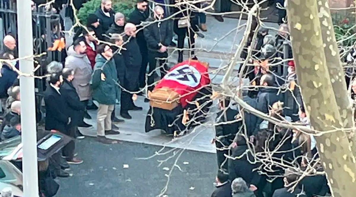People gathered around a swastika-covered casket outside the St. Lucia church, in Rome
