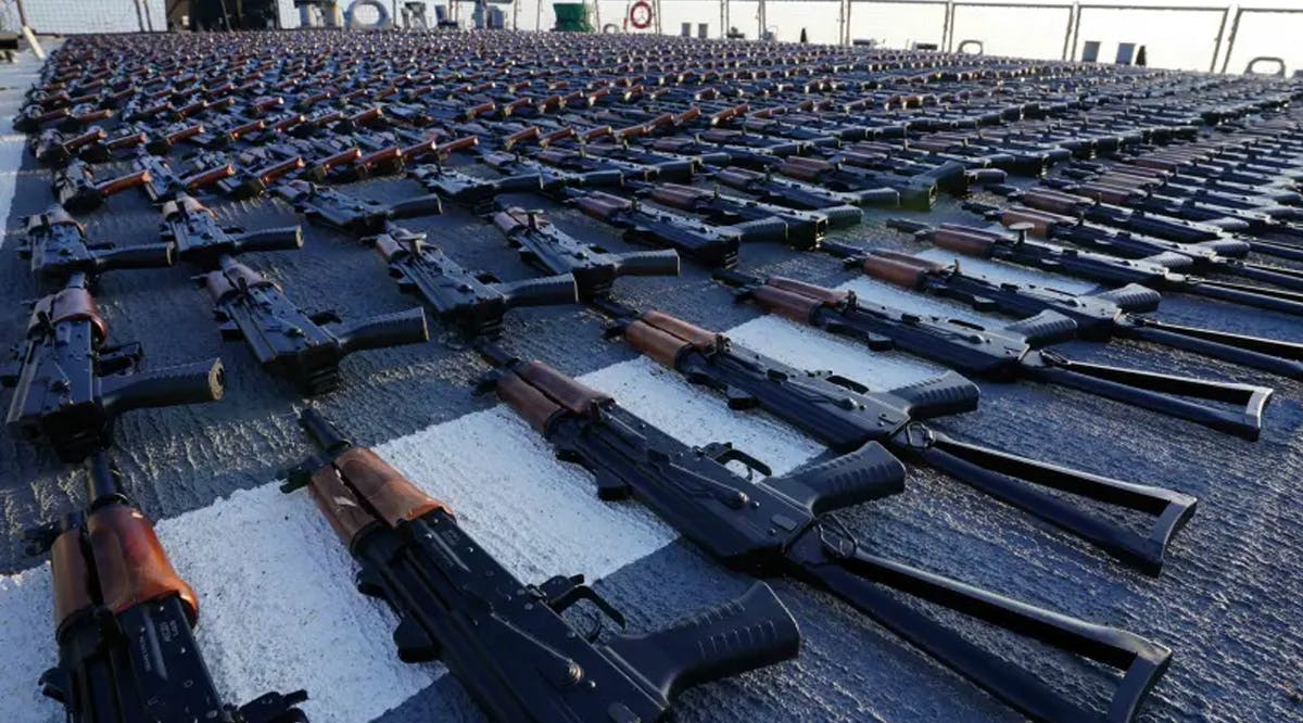 Thousands of AK-47 assault rifles sit on the flight deck of guided-missile destroyer USS The Sullivans