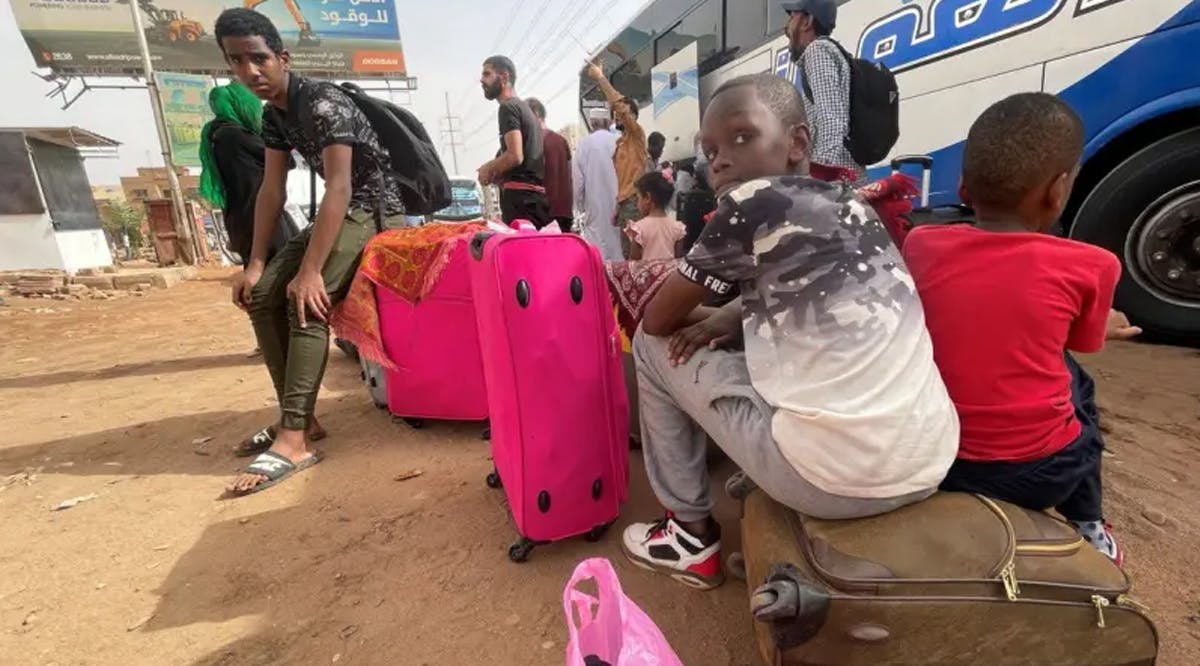 People gather as they flee clashes between the paramilitary Rapid Support Forces and the army in Khartoum, Sudan