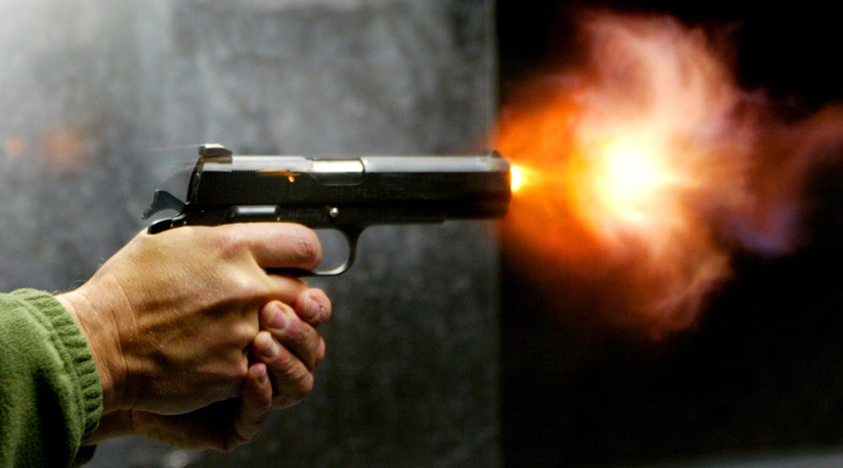 An Israeli man fires a pistol at a shooting range in Jerusalem