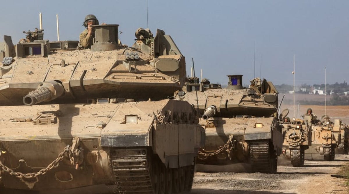 Israeli tanks and military vehicles take position near Israel's border with the Gaza Strip