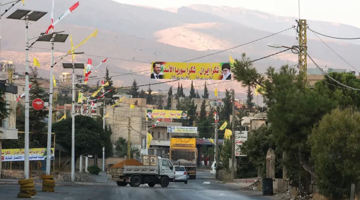 Banners depicting Syria’s President Bashar Assad, and Iran’s Supreme Leader Ayatollah Ali Khamenei
