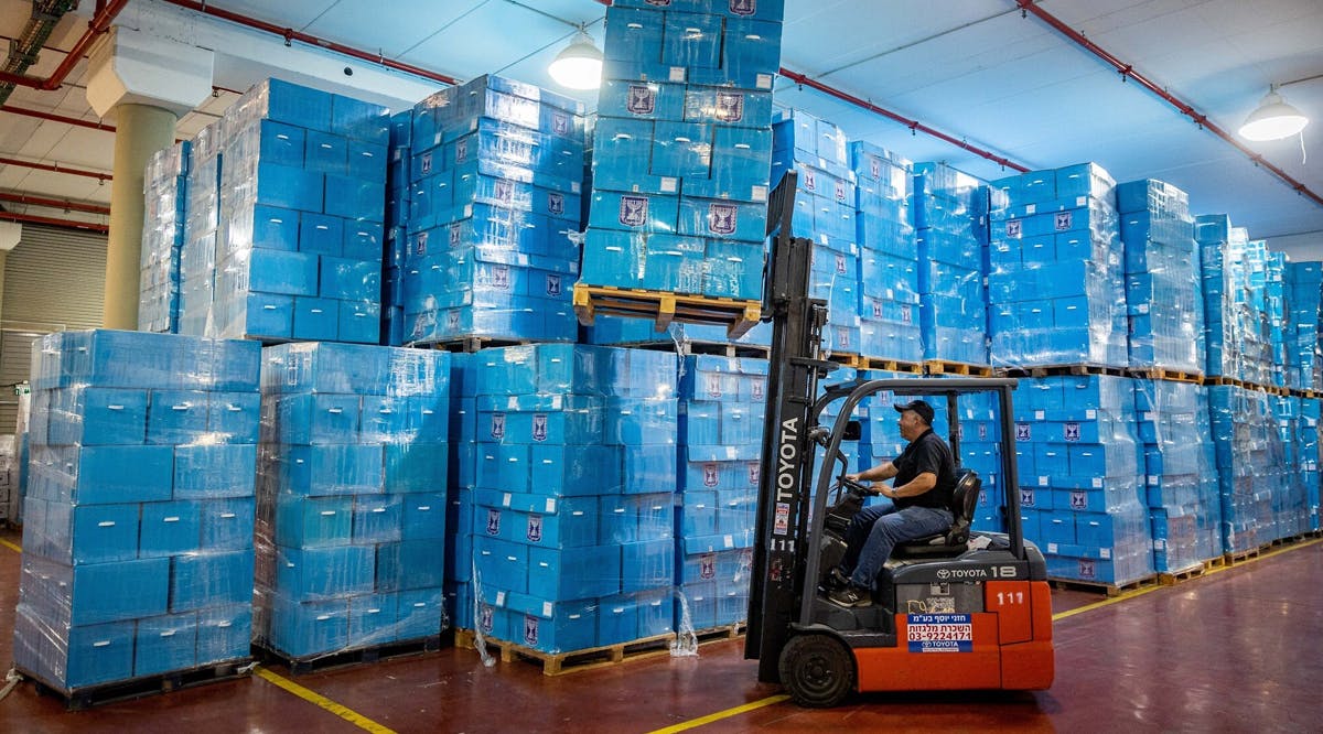 Workers prepare ballot boxes for the upcoming Israeli elections, at the Central Elections Committee warehouse