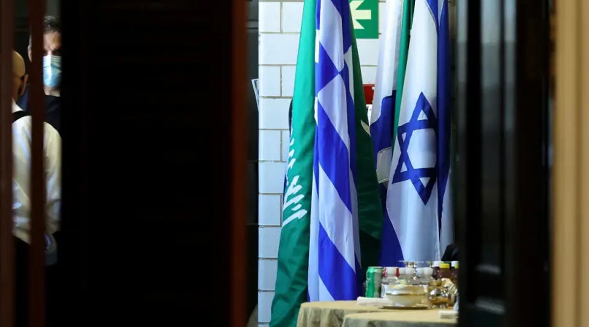 Flags of Saudi Arabia and Israel stand together in a kitchen staging area as US Secretary of State Antony Blinken holds meetings at the State Department in Washington