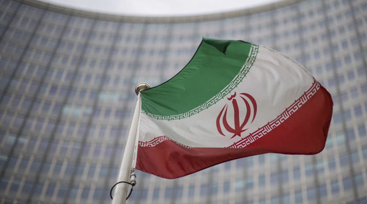 A national flag of Iran waves in front of the building of the International Atomic Energy Agency