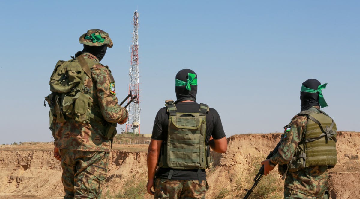 Hamas terrorists take part in a military parade