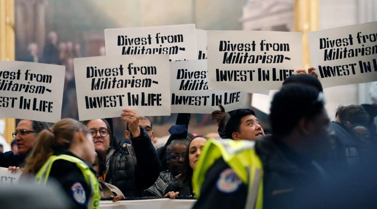 People display signs, chant, and sing as they await arrest during a protest in the US Capitol rotunda to call for a permanent ceasefire in Gaza