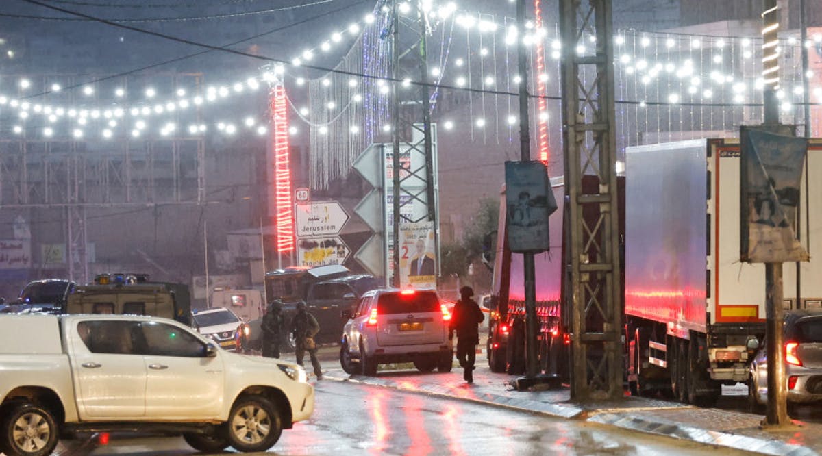 Israeli troops stand guard, at the scene of a shooting, in Huwara