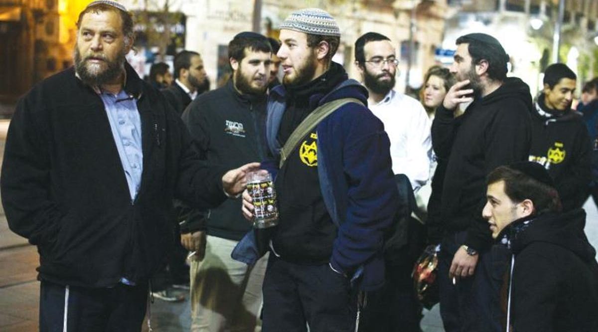 Ben-Zion Gopstein (left), leader of the group Lehava, gathers with some of his young followers in Jerusalem