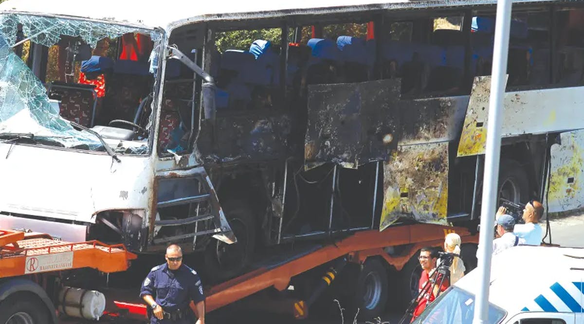 A truck carries the bus that was damaged in a bomb blast outside Burgas Airport