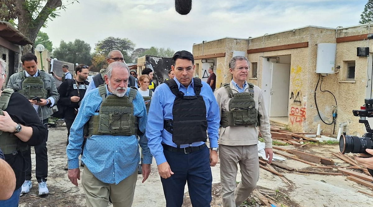 Former Arkansas Governor Mike Huckabee (left), MK Danny Danon (center) and former Kansas Governor Sam Brownback (right) at Kibbutz Kfar Aza