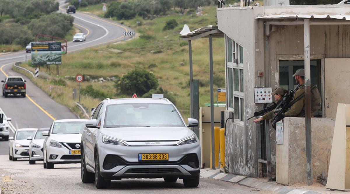 Israeli soldiers guard at a checkpoint not far from the scene of a shooting attack, in the Northern West Bank