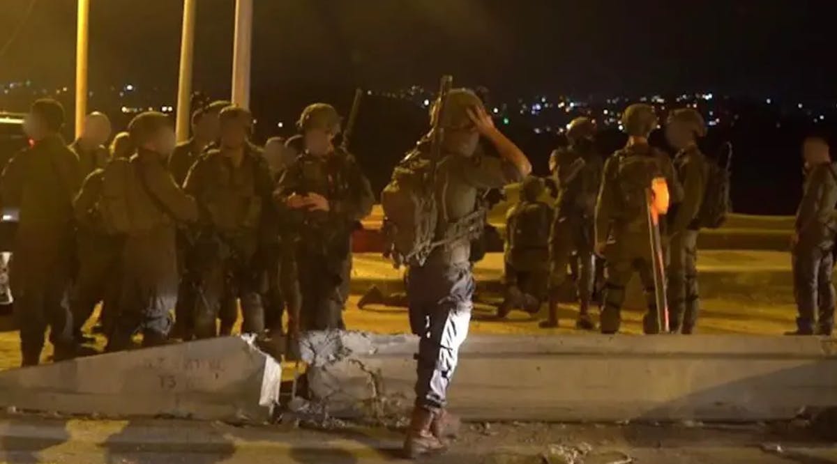 IDF soldiers after a man was killed in a drive by shooting at the entrance to Ariel