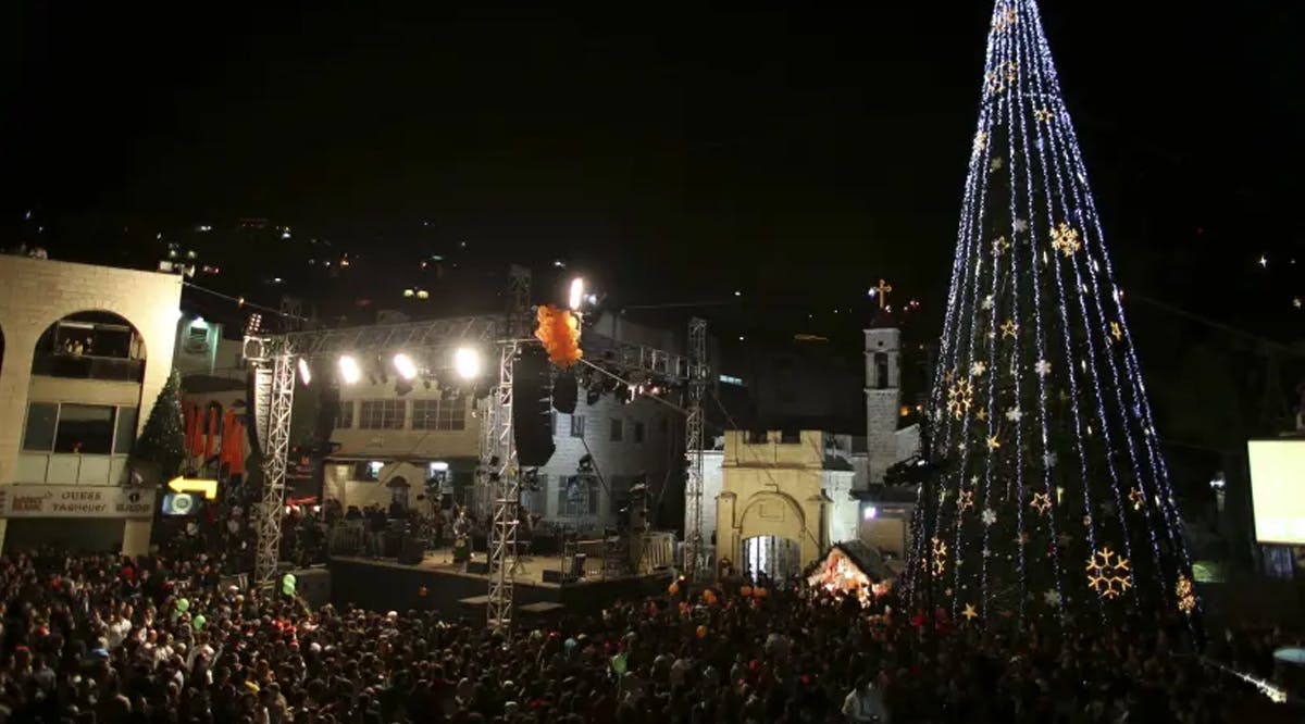 People attend a Christmas tree lighting ceremony in Nazareth