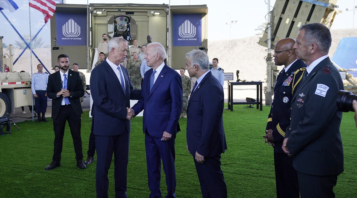 US President Joe Biden talks with Defense Minister Benny Gantz, left, and Prime Minister Yair Lapid, right, as he is shown views of aerial defense systems