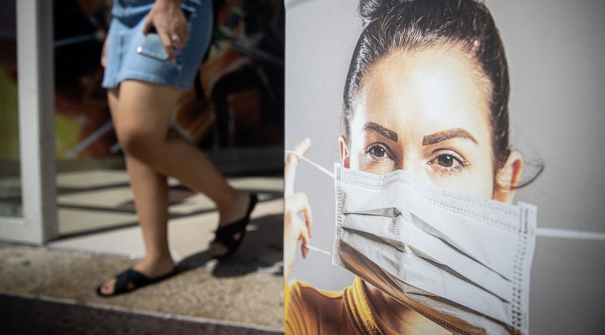 A sign instructing people to wear face masks in closed places, outside the Cinema City in Jerusalem