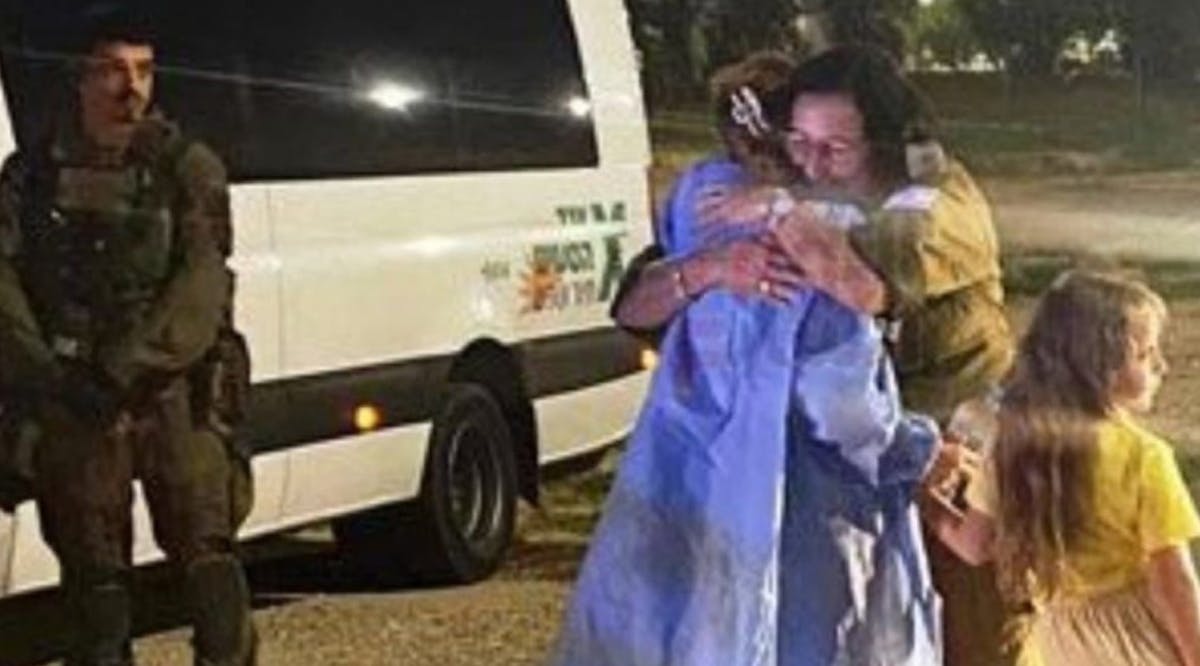 An Israeli hostage and her daughter are seen hugging an IDF officer amid their release from Hamas captivity