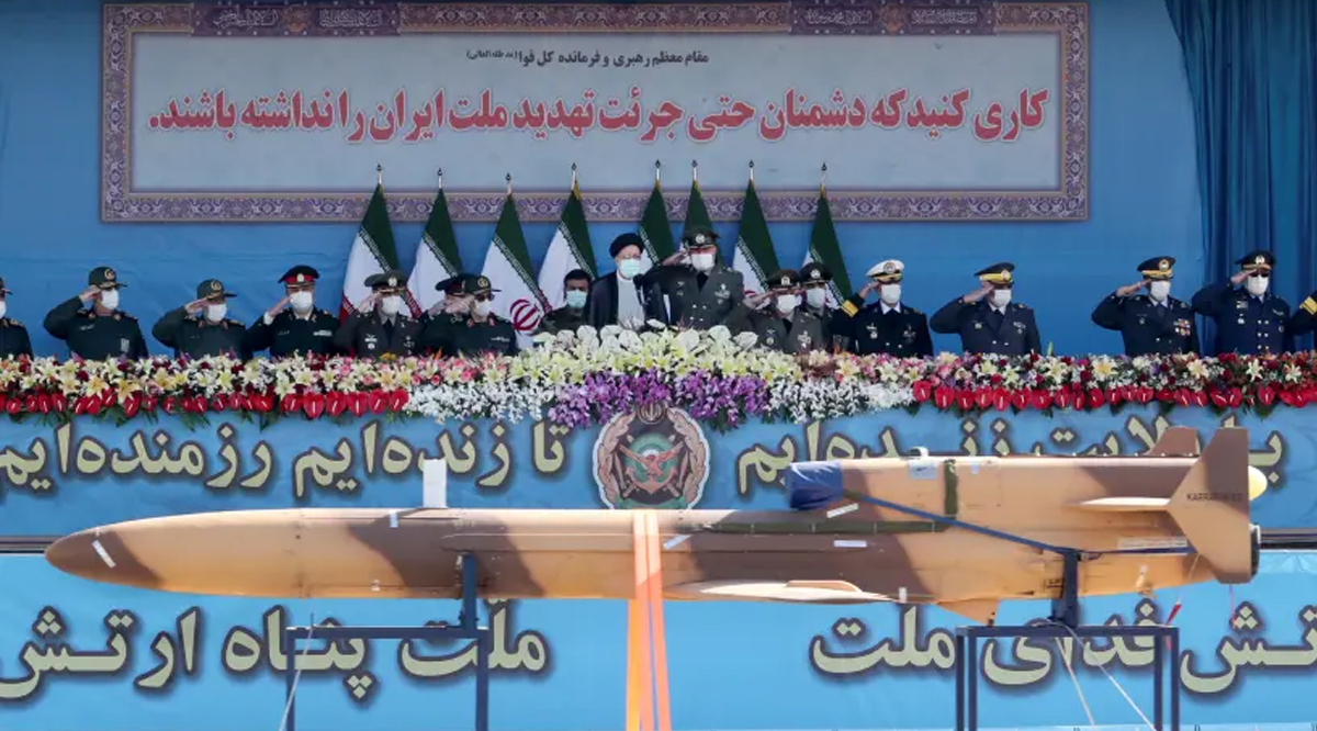 Iranian President Ebrahim Raisi and military commanders watch as military equipment passes by during a ceremony of the National Army Day parade in Tehran, Iran