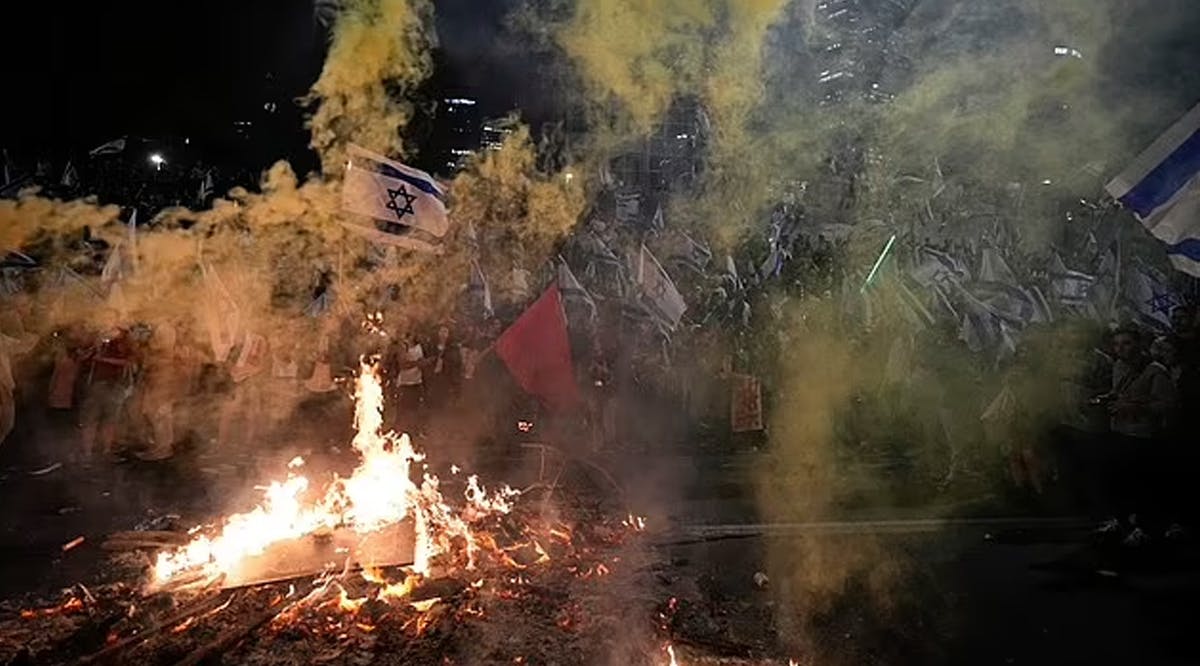 Protesters set up a large bonfire in the middle of the highway as tens of thousands turned out