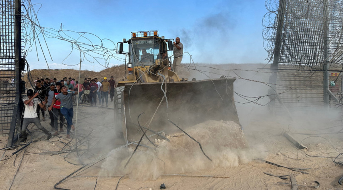 Palestinians break into the Israeli side of Israel-Gaza border fence after Hamas terrorists infiltrated areas of southern Israel