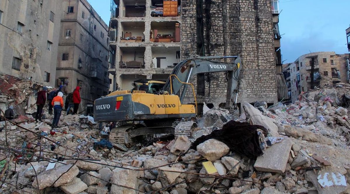 People gather on the rubble as the search for survivors continues, in the aftermath of the earthquake, in Aleppo, Syria