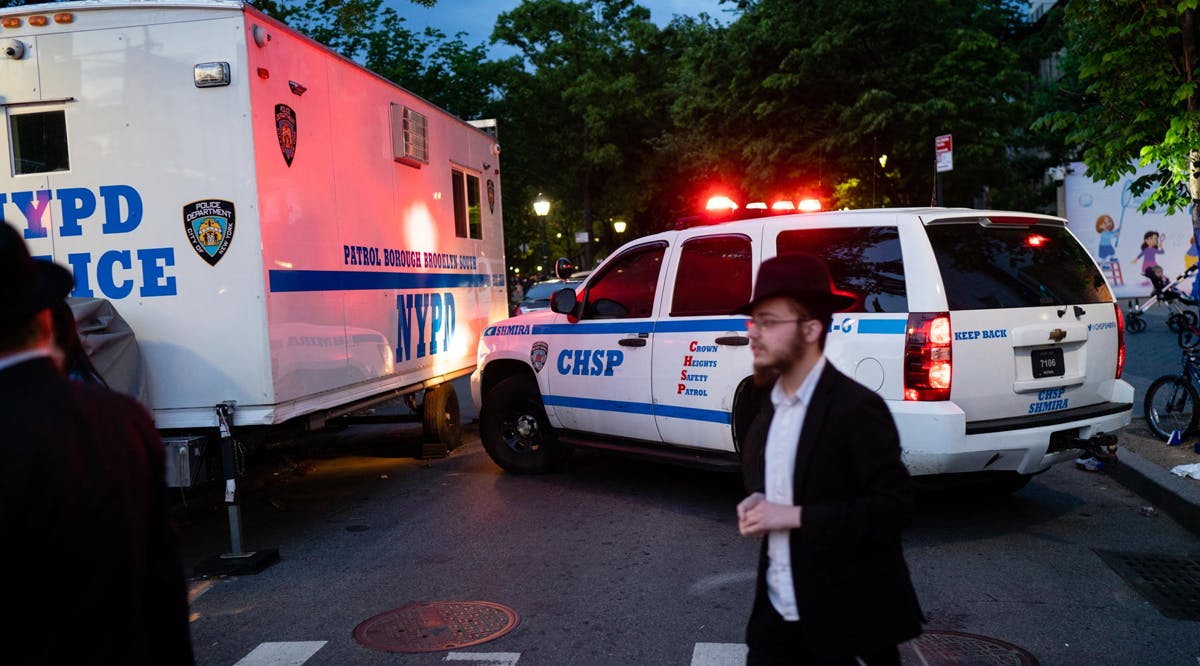 Police and community safety vehicles at a Jewish event in Brooklyn, New York City