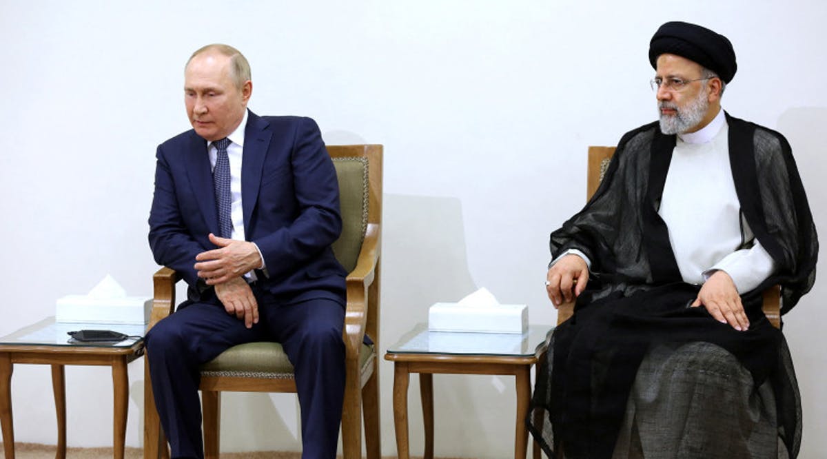 Russian President Vladimir Putin sits next to Iranian President Ebrahim Raisi