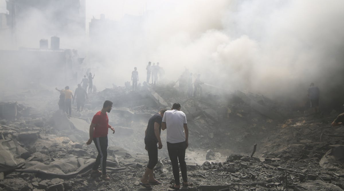 Palestinians look for survivors after an Israeli airstrike in the Rafah refugee camp, southern Gaza Strip