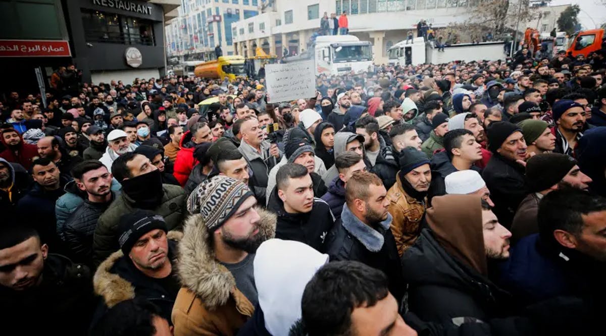 Palestinians take part in a protest against rising prices in Hebron