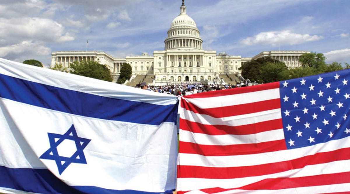 AMERICAN AND ISRAELI flags fly during a demonstration in support of Israel at the US Capitol