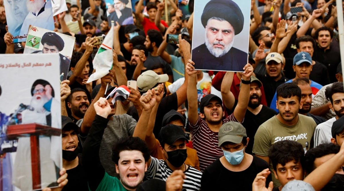 Supporters of Iraqi cleric Muqtada al-Sadr celebrate after Iraq's parliament passed a law criminalising normalization of relations with Israel