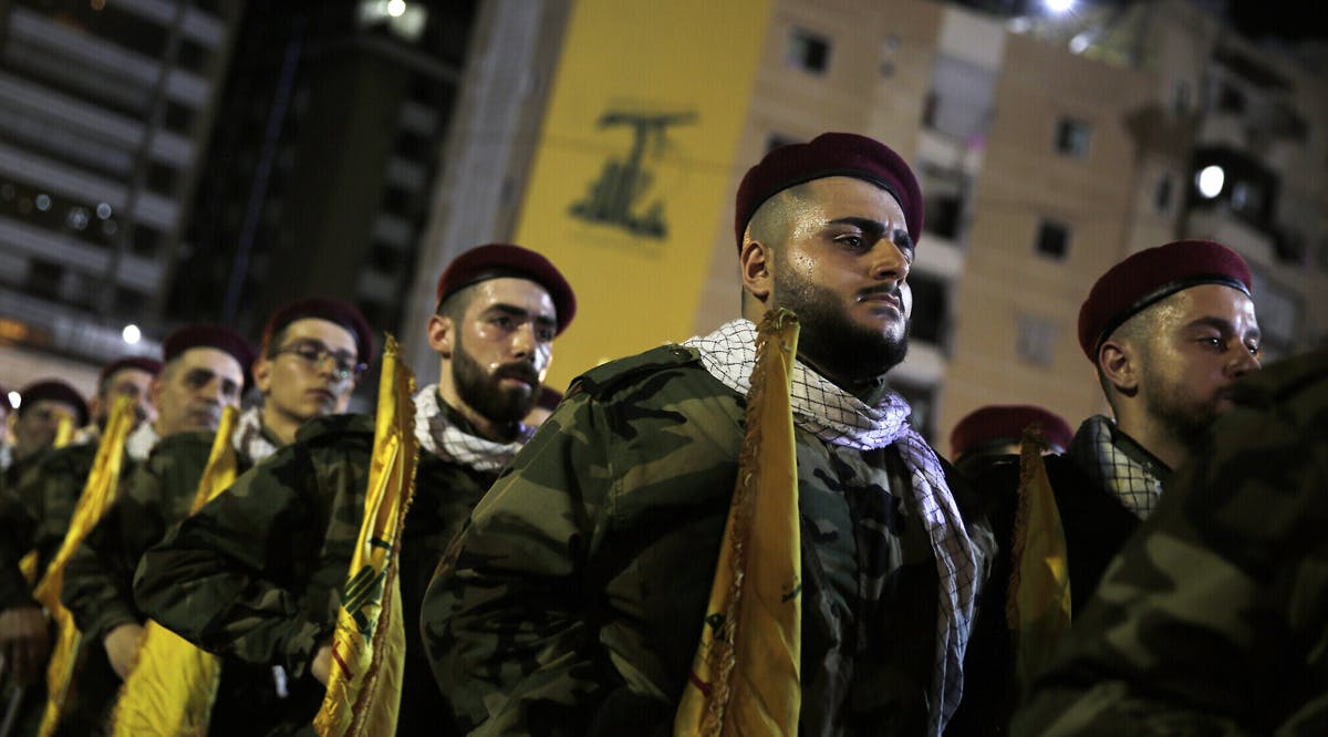 Hezbollah operatives stand in formation at a rally